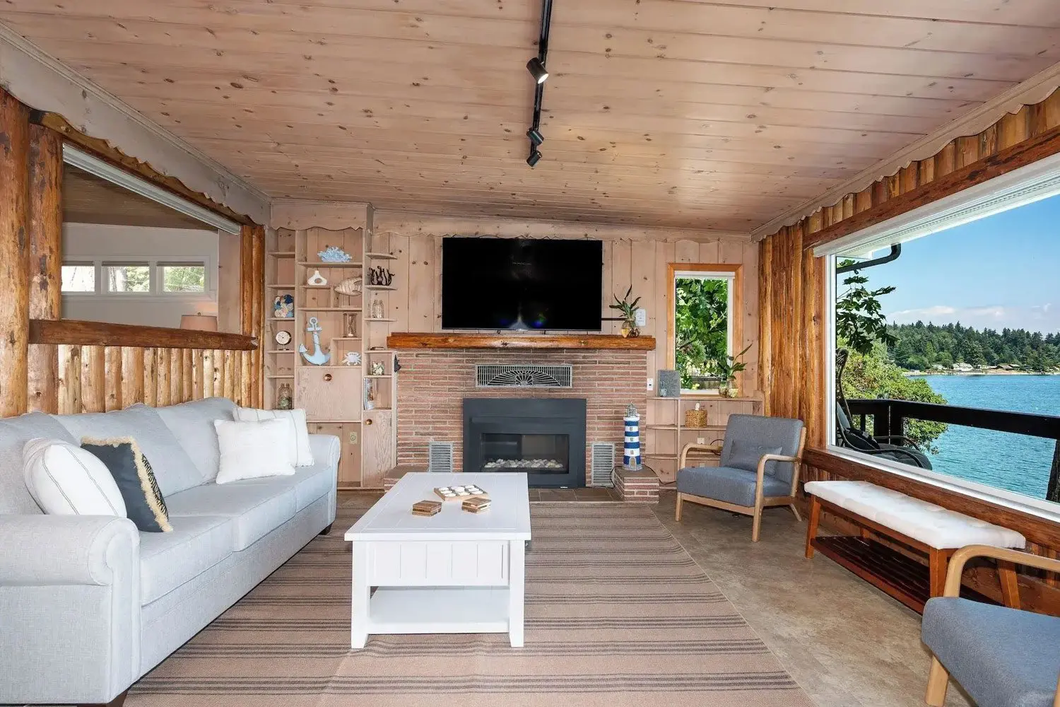 A living room with a couch, chair and television.