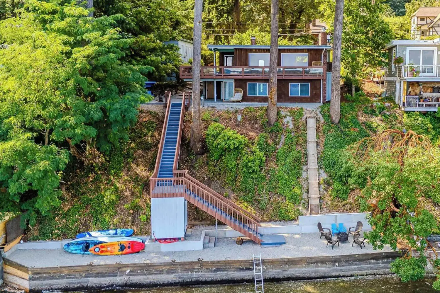 A house with stairs going up to the top of it.