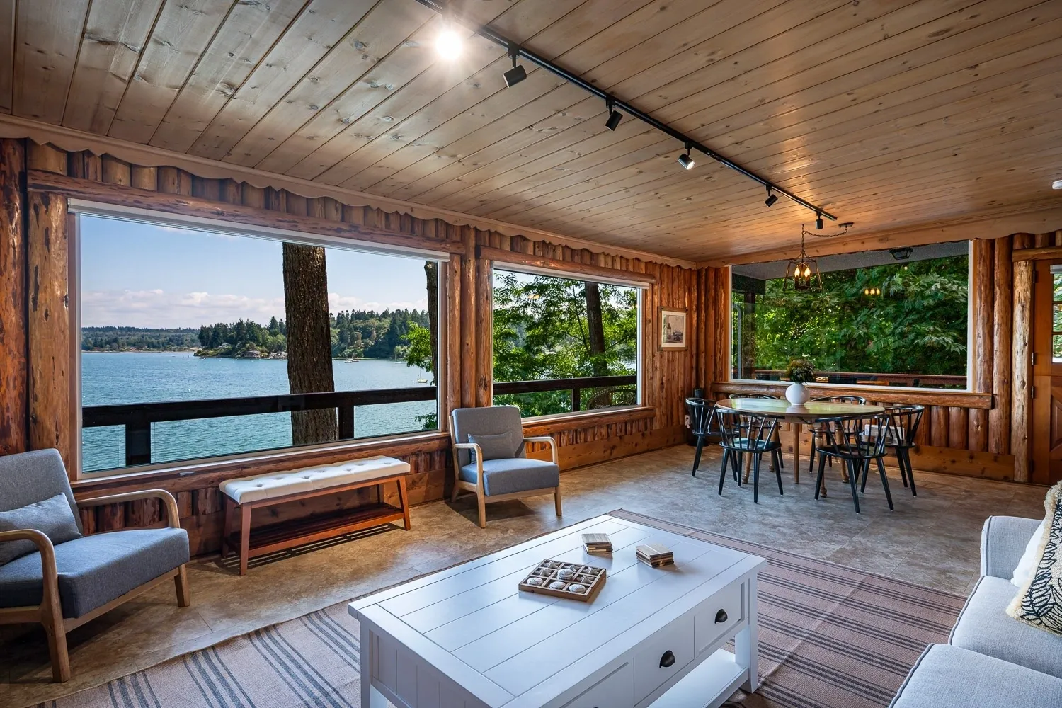 A living room with large windows and a lake view.