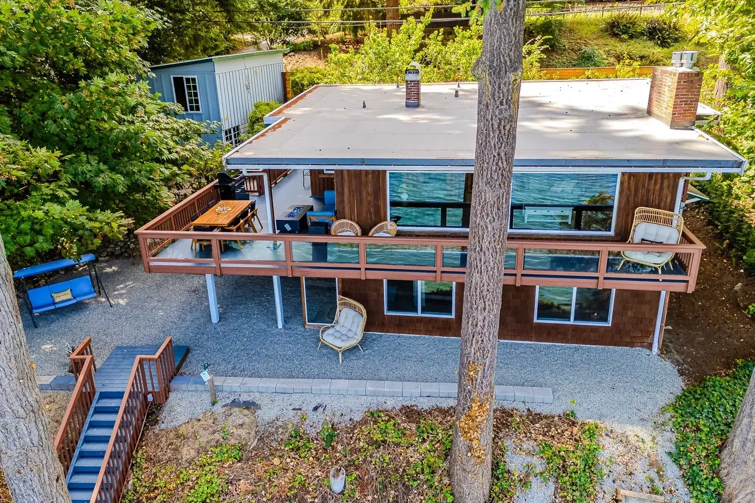 A house with a deck and patio in the back yard.