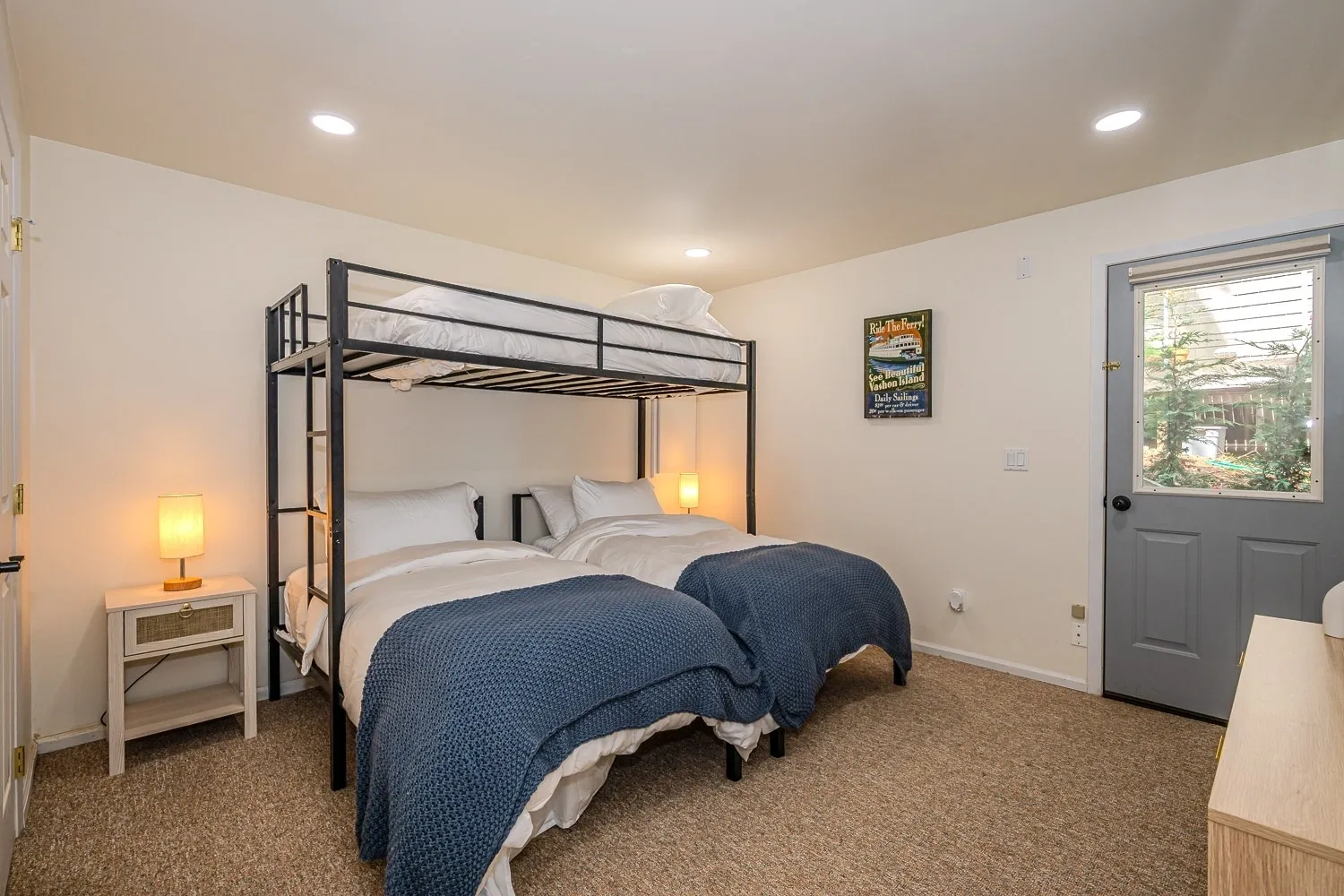 A bedroom with two beds and a refrigerator.