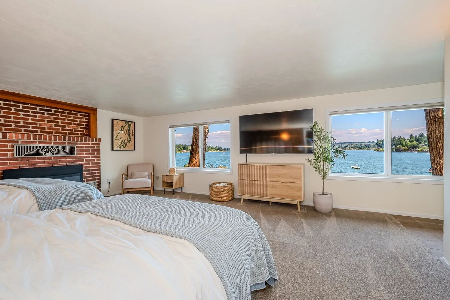 A bedroom with a large bed and a fireplace.